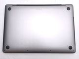 a close up of a silver laptop on a white surface