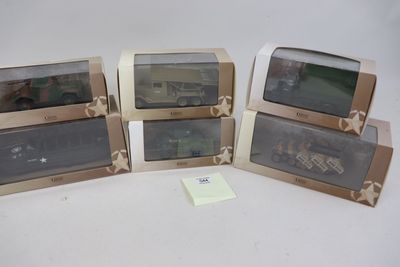 Quatre trains miniatures sont alignés sur une surface blanche