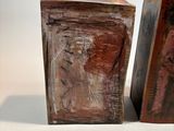 pair of wooden bookends with a painting of a man and a woman