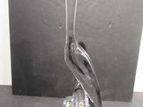 a glass sculpture of a bird sitting on a rock
