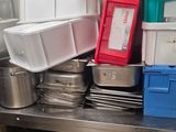 many containers that are stacked up on the kitchen counter
