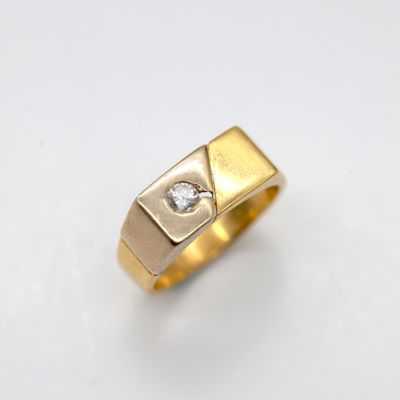 a close up of a gold ring with a diamond in the center