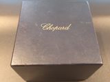 a black box with a gold logo on it on a table
