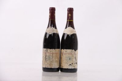 two bottles of wine sitting next to each other on top of a table