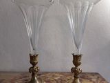 two vases sitting on a table with a marble table top