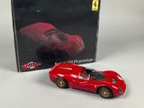 the box of a red toy car is next to the box of a red toy car