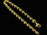a close up of a gold chain on a black background
