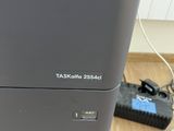 a black printer sitting on top of a wooden table