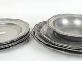 a lot of plates and bowls sitting on a table