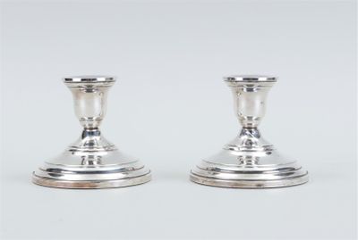 pair of silver candlesticks on a white background