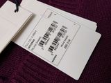 a tag that is attached to a sweater that has a barcode on it