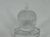 a clear glass figurine of a dog on a base
