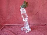 a glass vase with a flower in it on a red cloth