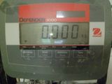 a close up of a digital scale with a clock on it