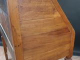 a small wooden desk with a drawer on top of it