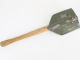 a green spatula with a wooden handle on a white surface