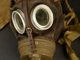 a gas mask with goggles on it sitting on a table