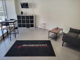 a living room with a couch, chair, table and television