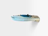 a small boat that is hanging on the wall