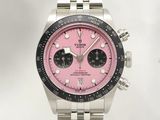a close up of a watch with a pink dial