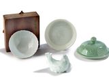 three bowls, a bowl, and a lid sitting on a table