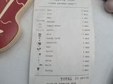 a receipt sitting on a table next to eggs and a cookie