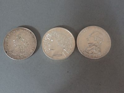 three different coins are sitting on a table next to each other