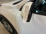 a white car with a measuring tape on the side of it