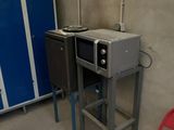 two microwaves sitting next to each other in a room