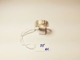 a close up of a gold ring on a string with a price tag