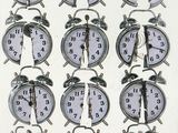 many clocks that are arranged in a row on the table