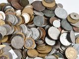 a pile of coins sitting on a white surface