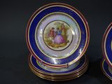pair of blue and gold plates with a picture of a man and a woman on them
