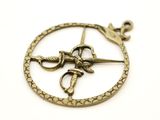 a picture of a pendant with scissors and a snake on it