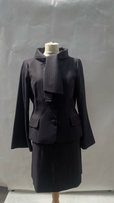 a mannequin with a black jacket on a mannequin stand