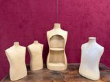 three mannequins and a shelf on a wooden table