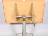a small wooden table with a metal stand on it