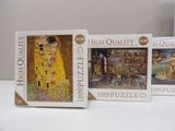 three puzzle pieces of the famous painting, the kiss, are on a table