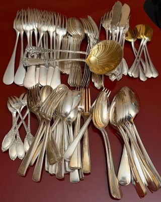 a lot of silver spoons and spoon spoons on the table