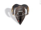a wooden mask with horns on a white background