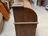 a wooden counter in the middle of a room full of furniture
