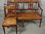 a wooden bench and two chairs sitting next to each other