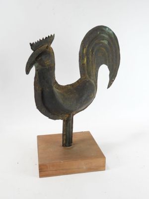 statue of a rooster on a wooden base on a white background