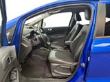 the interior of a blue car with the door open and the driver ' s seat down