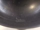 a large black bowl sitting on a white table