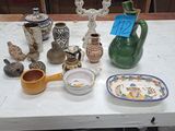 a table with a lot of vases and plates on it