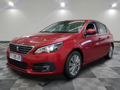 a red car is parked in a room with a checkered floor