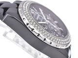 a black watch with a diamond bezel on the face