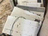 a pile of old televisions and other electronics in a room