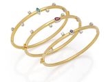 un lot de trois bracelets rigides en or et diamants